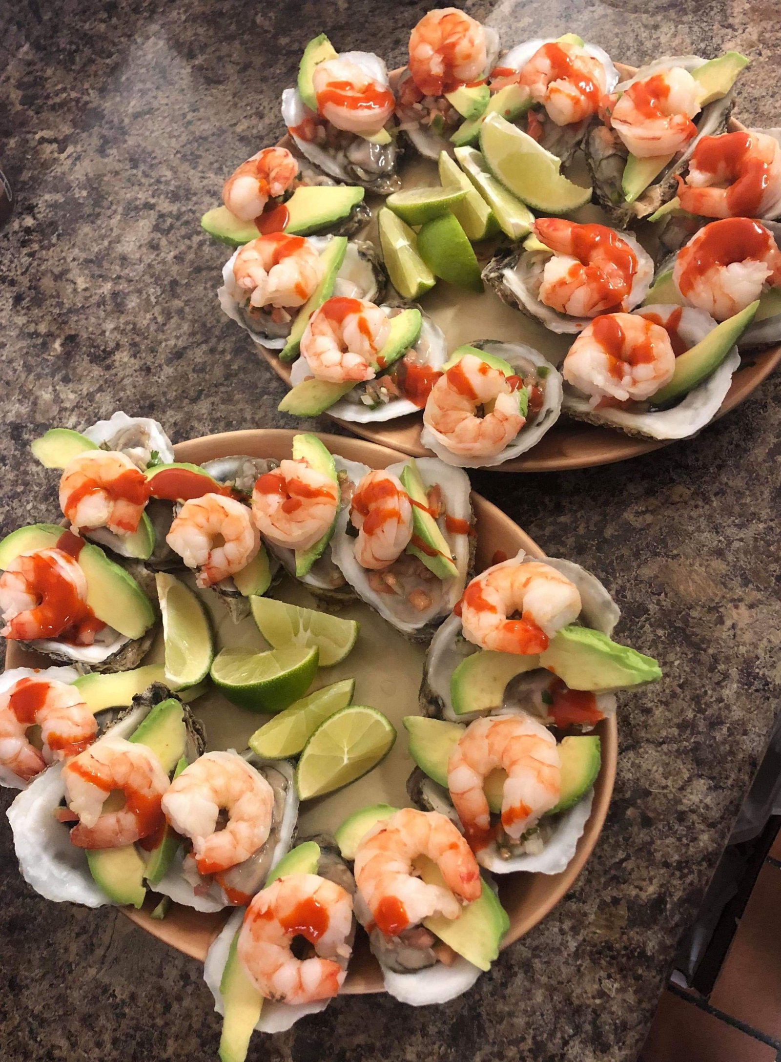Ostiones Charros - Fresh oysters topped with shrimp, avocado, and lime